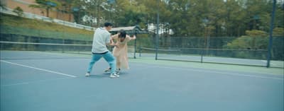 a man and a woman playing tennis on a tennis court