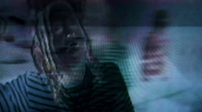 a blurry image of a woman with dreadlocks