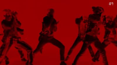 a group of people are dancing on a red background