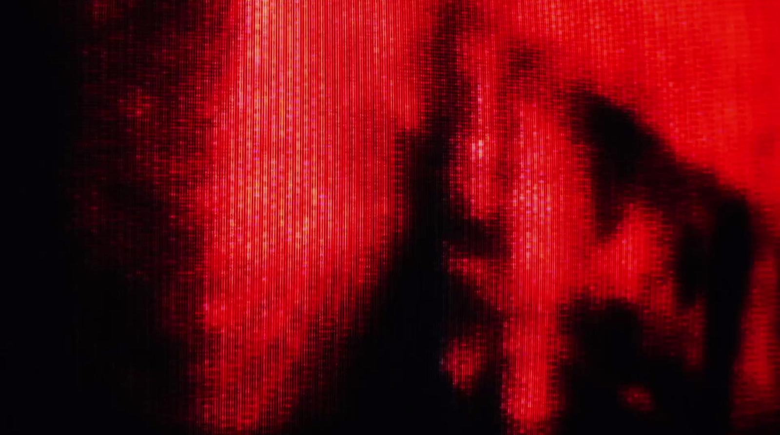 a blurry image of a person's face in red