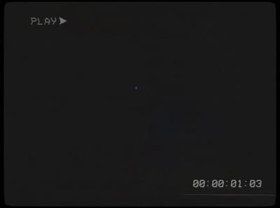a dark picture of a plane flying in the sky