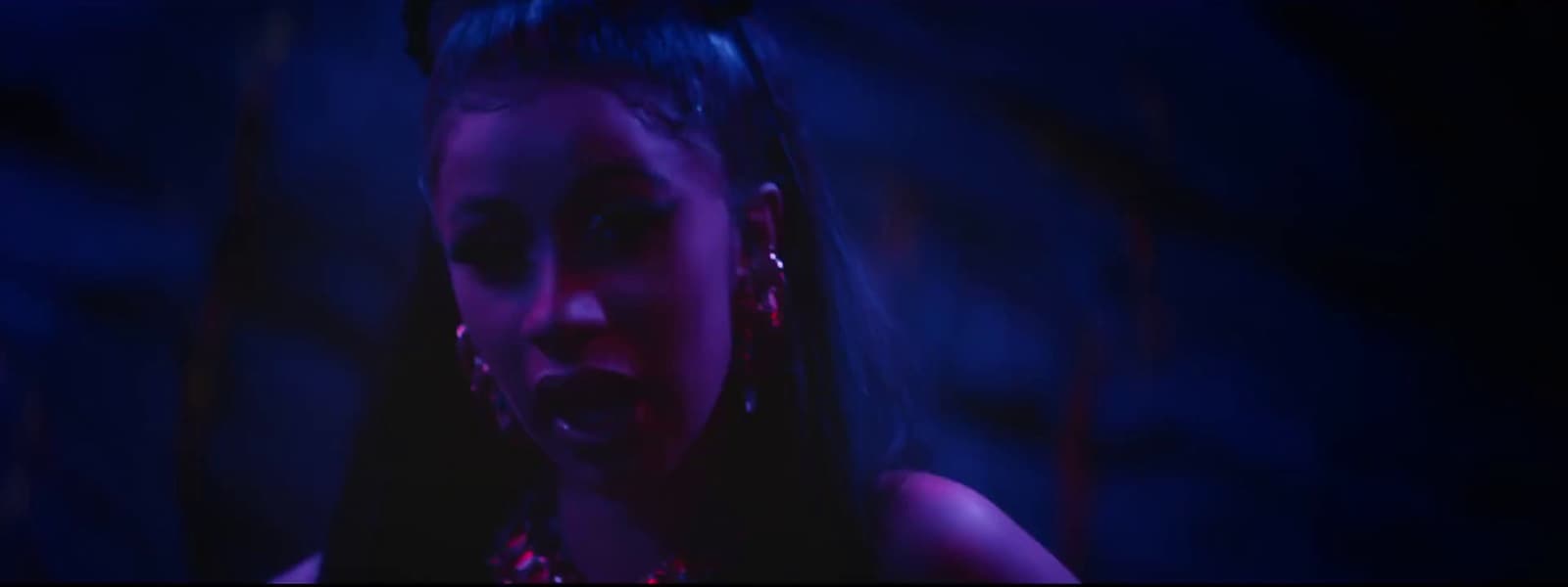 a young girl in a dark room with a creepy look on her face