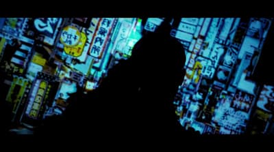 a man standing in front of a tv screen