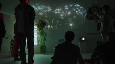 a group of people standing in a dark room