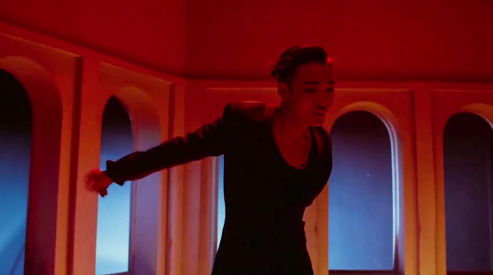 a woman standing in a room with a red light