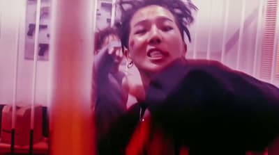 a woman with dreadlocks talking on a cell phone