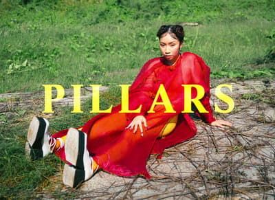 a woman in a red dress sitting on the ground