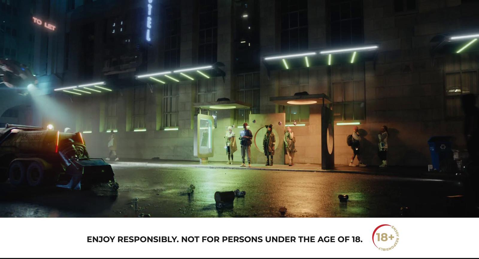 a group of people standing outside of a building at night