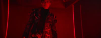 a man standing in a room with red lights