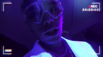 a woman wearing goggles and a white jacket