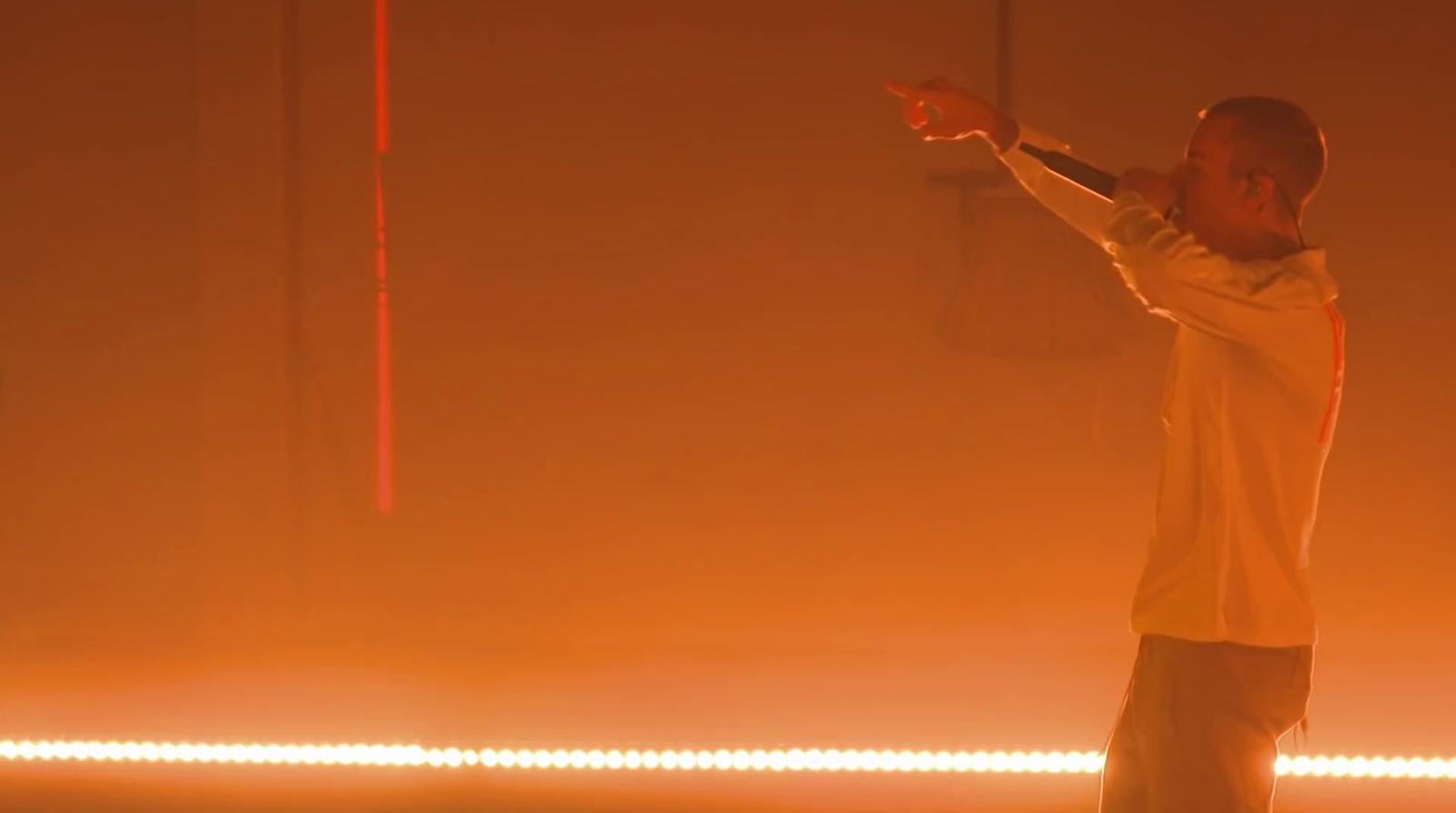a man standing in front of a yellow light