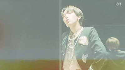a man in a black jacket and a white shirt