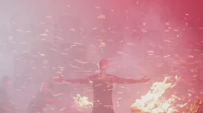 a person standing in front of a fire