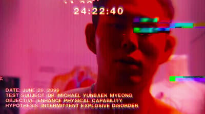 a man with glasses is looking at the camera