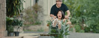a man pushing a child in a shopping cart