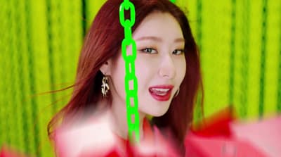 a woman with a green chain around her neck