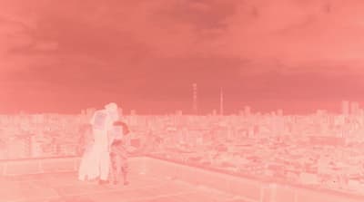 a couple of people standing on top of a building