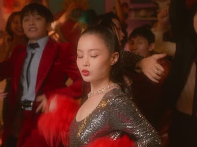 a group of people in a room with red feathers