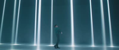 a woman standing in front of a wall of lights