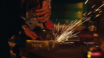 a person using a grinder on a piece of metal