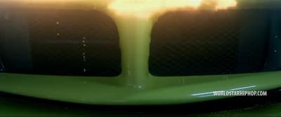 a close up of the front of a green sports car