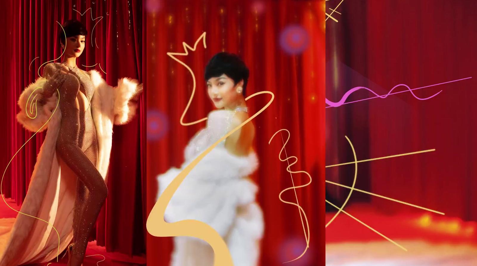 a woman in a white dress standing in front of a red curtain