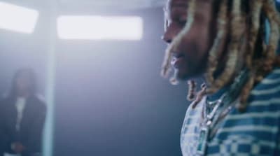 a man with dreadlocks standing in a room