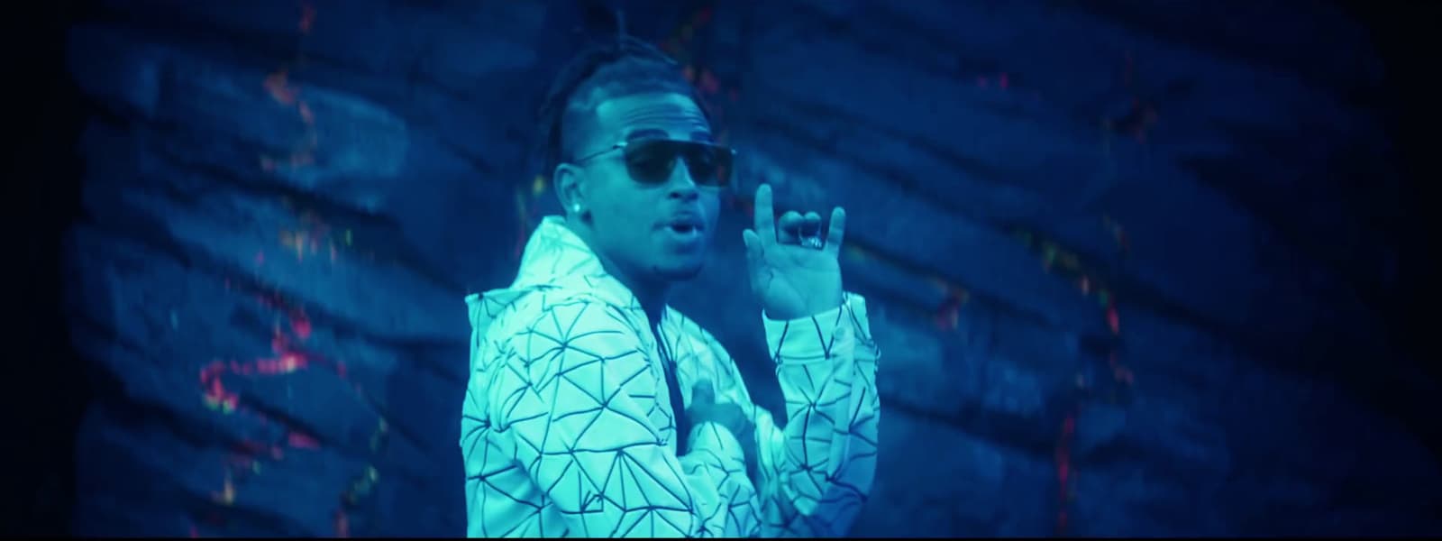 a man wearing sunglasses and a white jacket