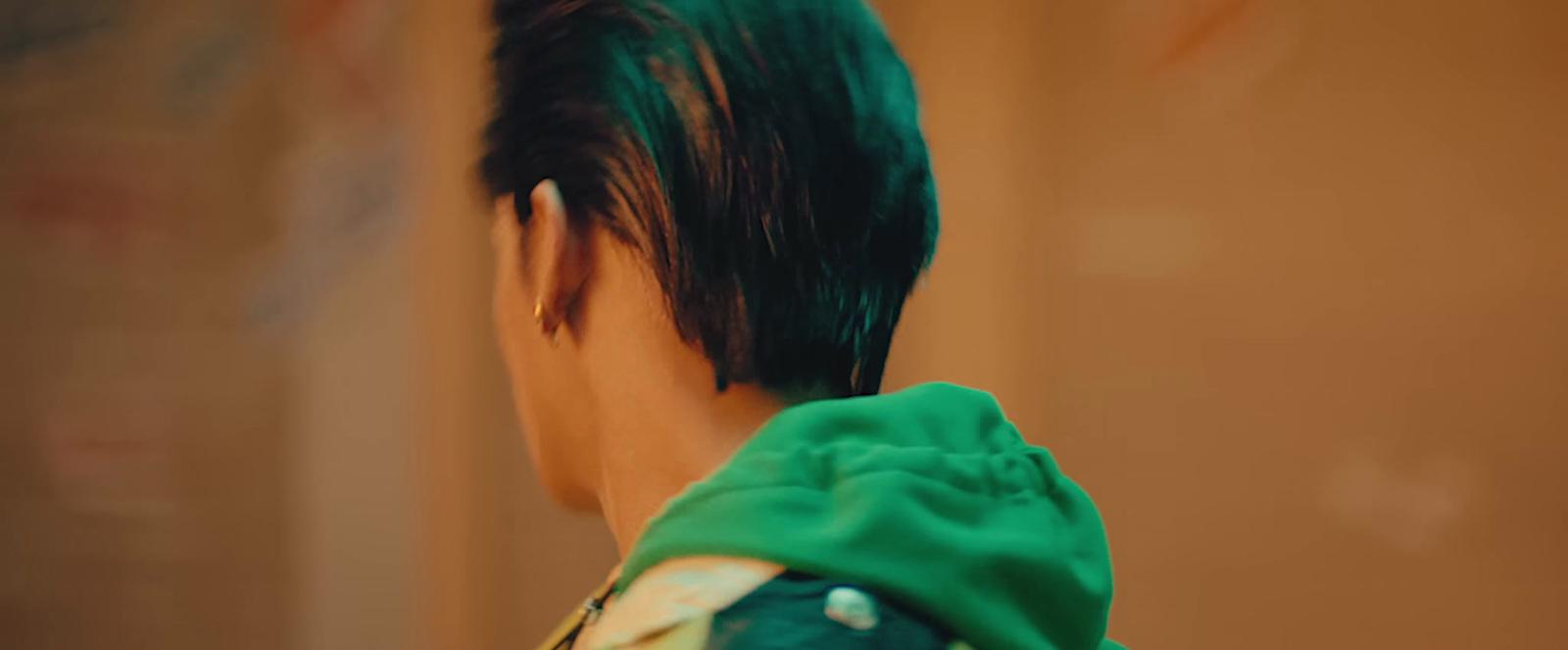 a close up of a person with green hair