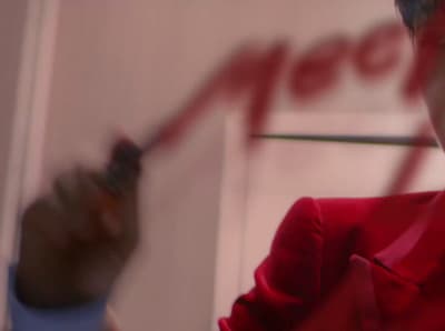 a man in a red suit holding a cell phone
