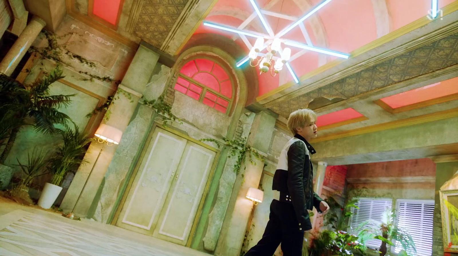 a person walking in a room with a chandelier