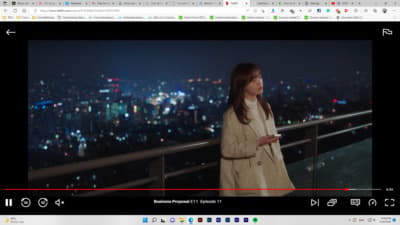 a woman standing on top of a balcony next to a city