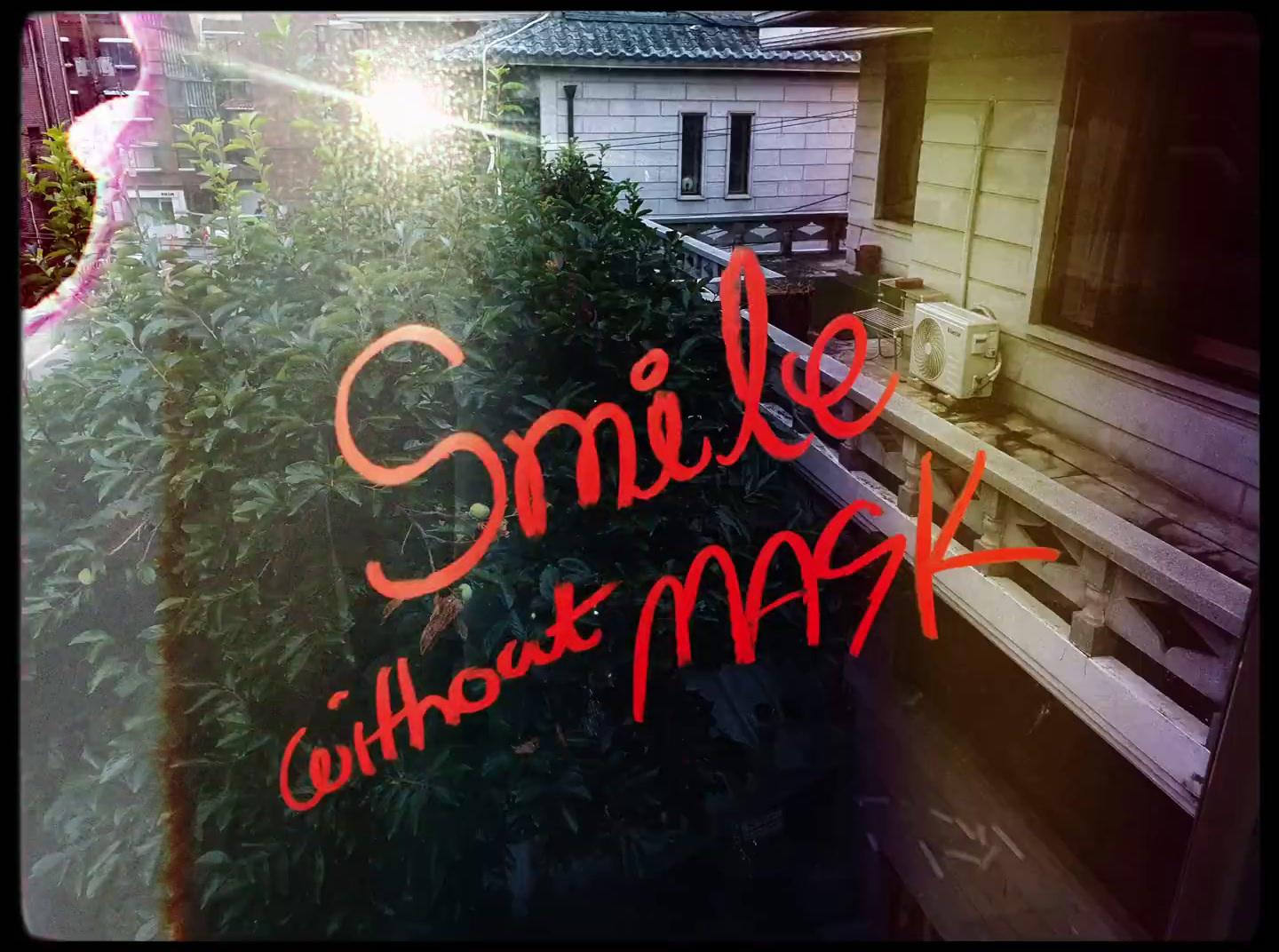 a window with the words smile without mask on it