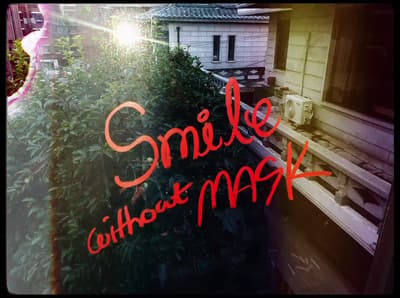 a window with the words smile without mask on it