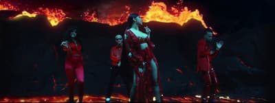 a group of women standing in front of a fire