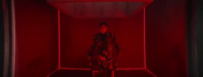 a person standing in a red room with a red light