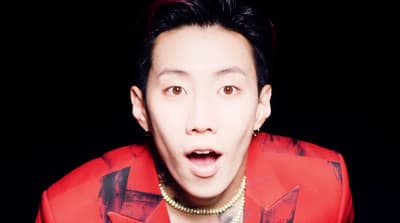 a man in a red shirt making a surprised face