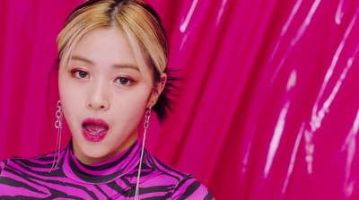 a woman in a zebra print shirt and earrings