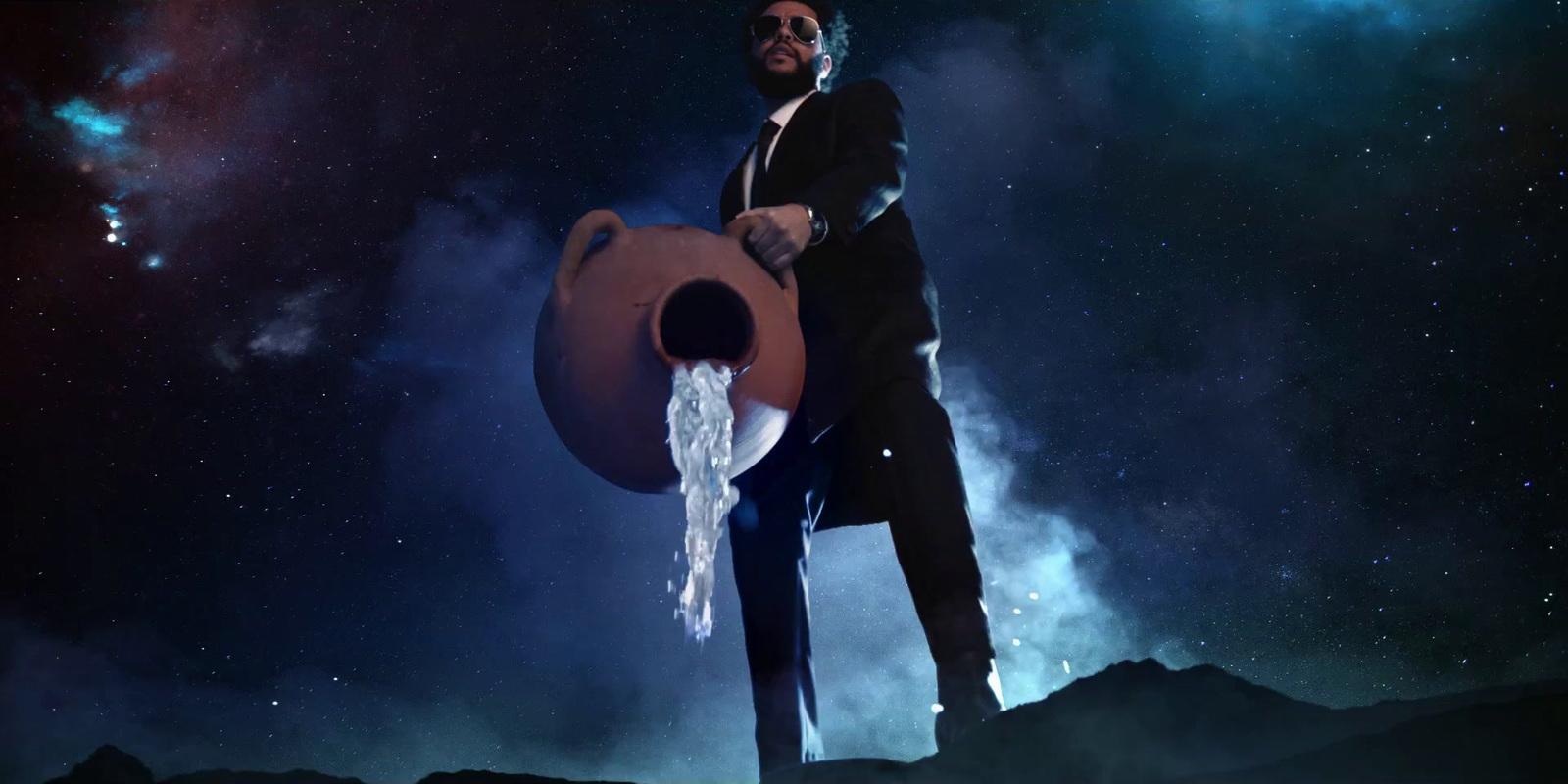 a man in a suit is holding a water jug