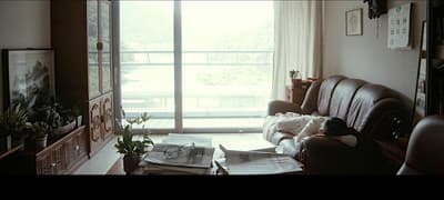 a living room filled with furniture and a large window