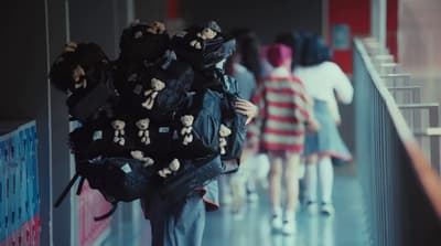 a group of people walking down a hallway