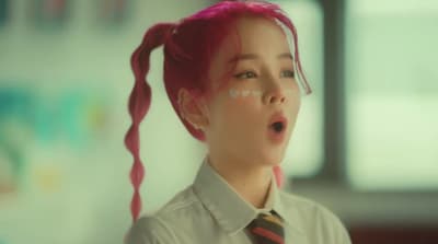 a woman with pink hair wearing a tie