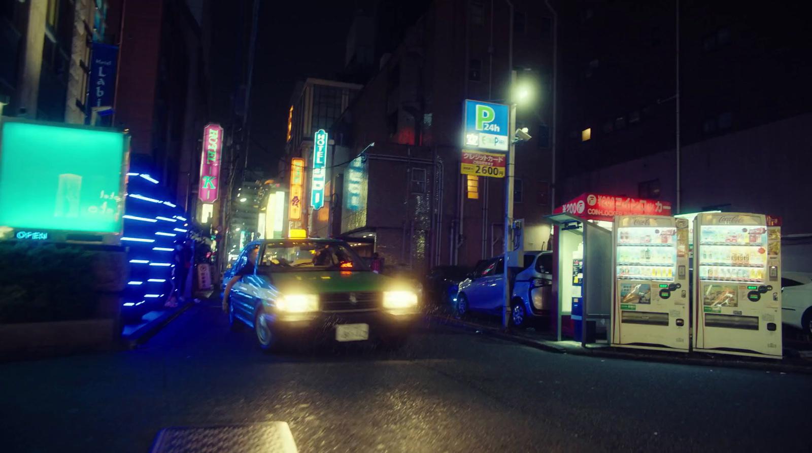 a car driving down a city street at night