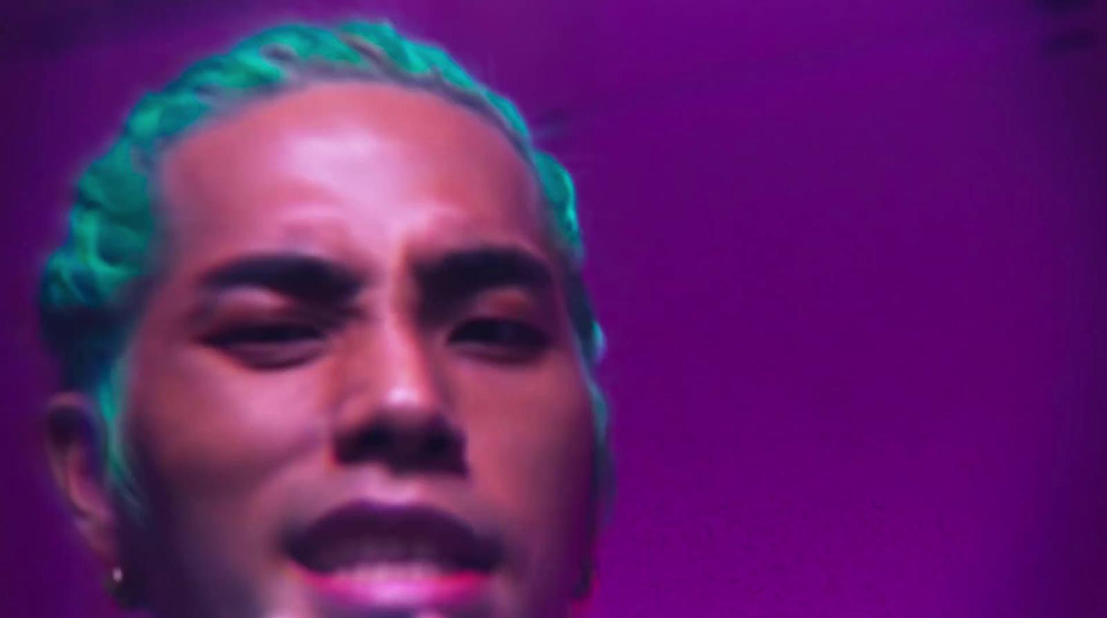 a close up of a person with green hair