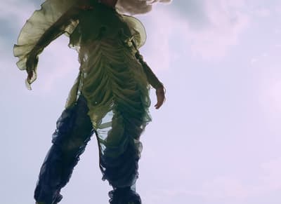 a woman dressed in a costume is flying through the air