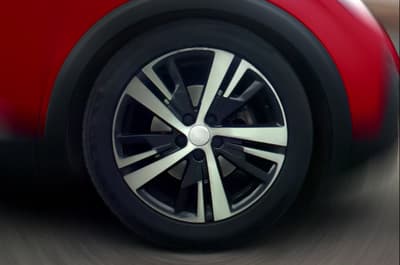 a close up of a car wheel on a road