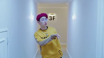a boy in a yellow shirt and a red hat