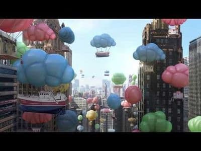 a city filled with lots of balloons floating in the air