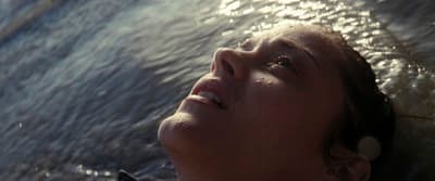 a close up of a person laying in the water