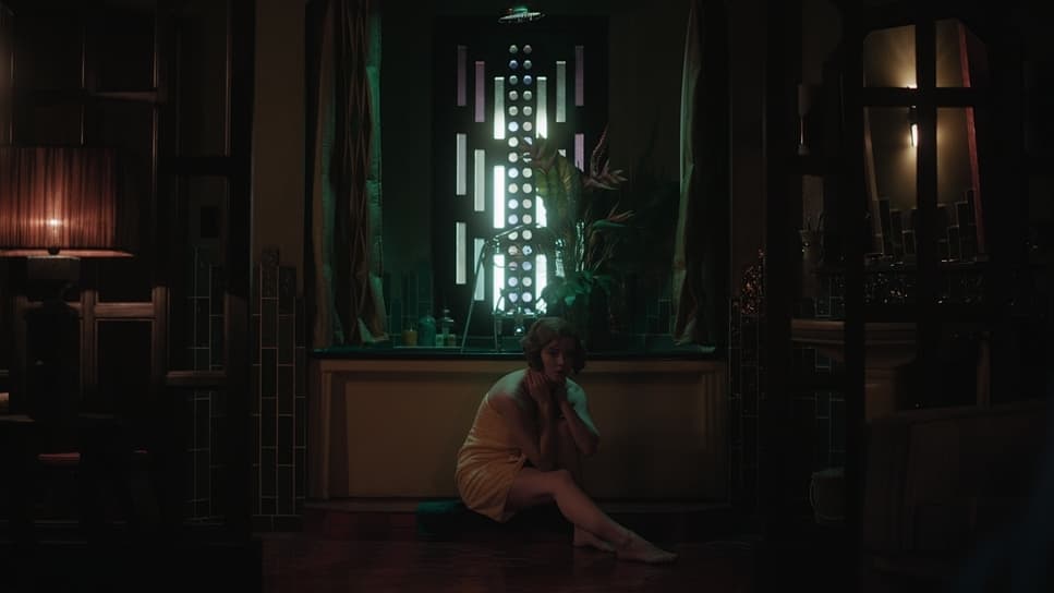 a woman sitting on the floor in front of a window